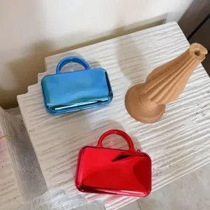 Detailed view of the luxury mirror metallic finish handbag, elegant red and blue evening clutch.