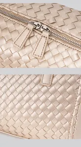 Detailed view of gold woven leather handbag zipper and premium intrecciato texture design.