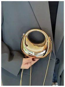 Gold metallic mini handbag detail shot, featuring a unique ring handle and chic chain strap.