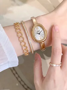 Detaillierte Ansicht einer goldenen Retro Oval Quarzuhr kombiniert mit edlem Schmuck Set.