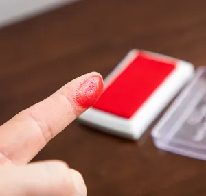 Red ink stamp pad for kids fingerprint art and painting, safe washable pigment detail shot.