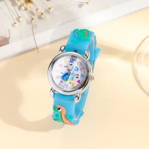 Close-up detail of children quartz watch with blue 3d cartoon dinosaur silicone strap.