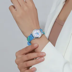 Close-up detail view of the cute cartoon dinosaur quartz watch with blue silicone strap.