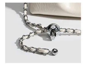Detailed view of a stylish women cloud bag with metal chain and adjustable sphere lock.
