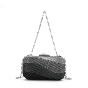 Close-up view of the sparkling rhinestone evening clutch showcasing exquisite wavy design and chain.