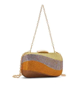 Rhinestone evening bag detail, crystal clutch with gold chain, gradient wave design.