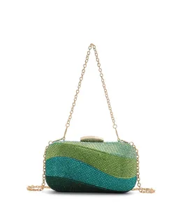 Luxury rhinestone evening clutch bag with chic color-block wave design and gold chain strap.