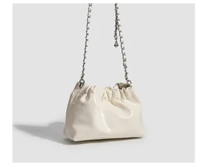 Detailed view of cream white ruched cloud bag with metal chain strap for daily wear
