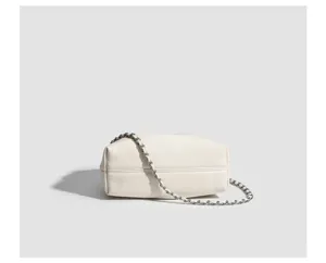 Detailed view of the white pleated cloud shoulder bag with stylish interwoven chain strap.