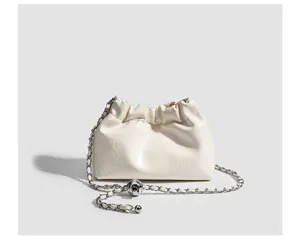 White gathered cloud pouch bag detail with silver chain strap and metal ball decor.