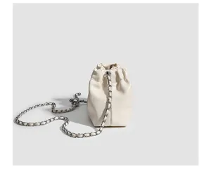 Detailed view of the elegant white ruched cloud bag featuring a stylish chain strap.