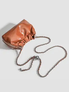 Women brown gathered cloud bag with chain strap, stylish leather crossbody purse for daily wear.