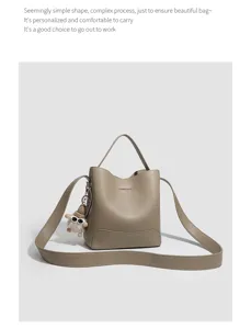 Stylish women's bucket bag featuring a top handle and adjustable shoulder strap for daily wear.