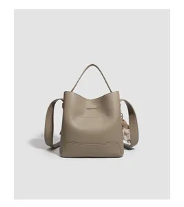 Close-up detail view of the stylish leather bucket bag showcasing fine texture and strap design.