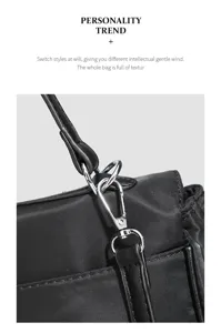 Close-up view of the black nylon bag hardware and leather strap detail, premium texture.