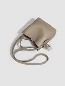 Stylish women bucket bag shoulder crossbody handbag with fluffy charm grey top angle main view