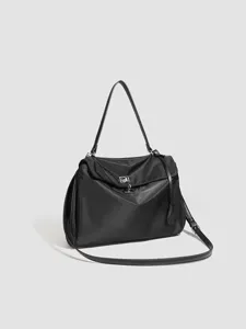 Black nylon shoulder bag with metal lock closure, spacious commuter tote for women.