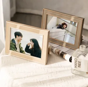 Detailed shot of minimalist wood picture frames on white textile, ideal for home decor.