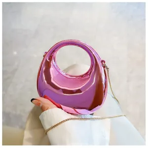 Glossy metallic pink mini handbag with round handle and gold chain strap for stylish daily wear.