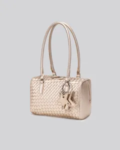Gold woven leather shoulder bag featuring double handles and an elegant star charm decoration.