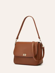 Classic brown leather shoulder bag detail, featuring retro metal clasp and stylish crossbody strap.