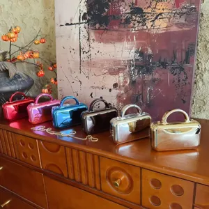 Detailed view of colorful metallic mirror finish hardcase evening clutch bags with chain.