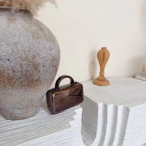 Elegant mirror finish mini handbag for women, chic metallic clutch purse for evening party use.