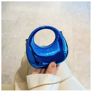 Stylish mini metallic blue shoulder bag with round top handle and chain strap for women.