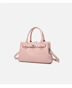Close-up detail of the pink leather handbag hardware and textured design, elegant style.