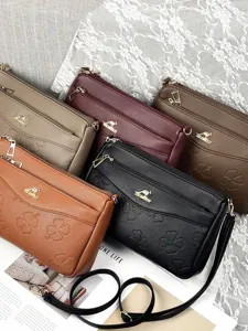 Multi-layer leather crossbody bag with clover embossing for daily commute and casual use style.