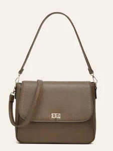 Brown pebbled leather shoulder bag detail, stylish gold geometric clasp and sleek strap design.