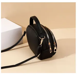 Black multi-layer crossbody bag featuring top handle, dual zippers and casual everyday design.