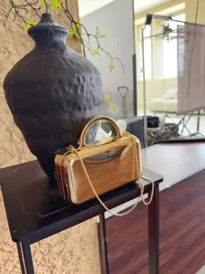 Gold metallic evening clutch bag with metal top handle and chain strap for women party wear