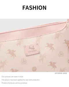 Pink leather shoulder bag detail, horse pattern embossed design and stylish logo badge.