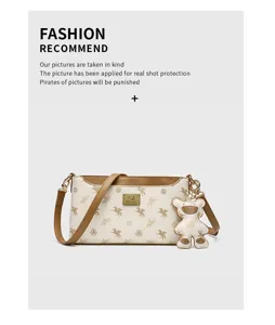 Stylish women shoulder crossbody bag featuring chic monogram pattern and cute bear pendant charm.