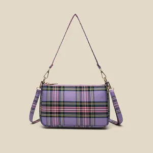 Purple plaid underarm bag detail showing stylish tartan pattern, gold zipper and shoulder strap.