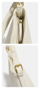 Detail van een elegante crèmekleurige hobo-schoudertas met glad leer en vintage messing beslag.