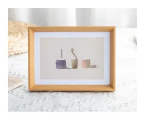 Wooden photo frame detail shot, retro style picture holder with abstract watercolor art insert.
