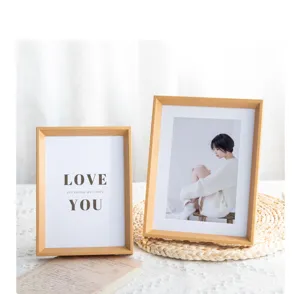 Wooden photo frame detail showing natural wood texture and warm home decor setting with inserts.