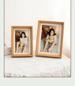 Detailed view of wooden picture frames on textured table, natural wood grain design.