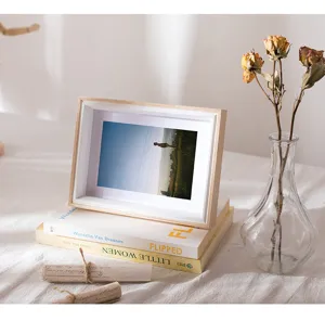 Wooden 7-inch photo frame detail shot, simple design with white mat on fabric table.