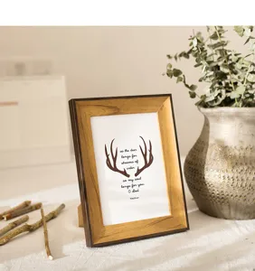 Vintage wood picture frame table standing photo display with botanical decor and quote insert.