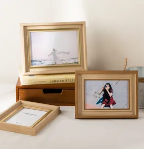 Wooden photo frame detail view showing natural wood grain texture and elegant desk display.