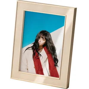 Modern minimalist tabletop photo frame with brushed gold finish for home decor and living room.