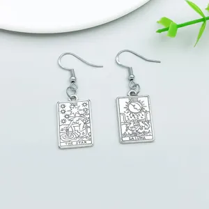 Vintage silver tarot card drop earrings detail shot, star and moon pendant jewelry.