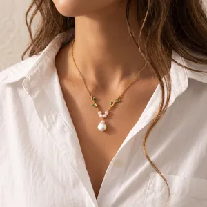 Exquisite baroque pearl twig necklace, featuring green zirconia and elegant gold finish detail.