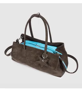 Details van bruine zachte lederen tote bag met blauwe voering, dubbele handgrepen en sterbedel.