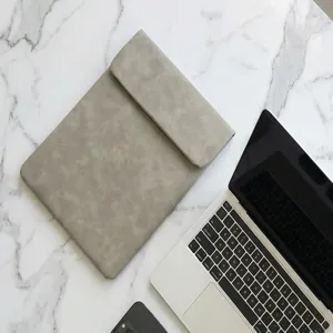 Details view of grey leather laptop sleeve and protective case for notebook and tablet.