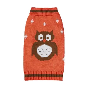 Close up detail of knitted pet sweater featuring cute owl pattern and winter snowflake motifs.