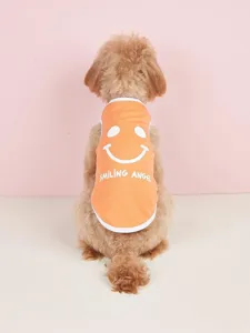 Cute summer dog vest detail showing orange fabric with a white smiley face and cute English print.